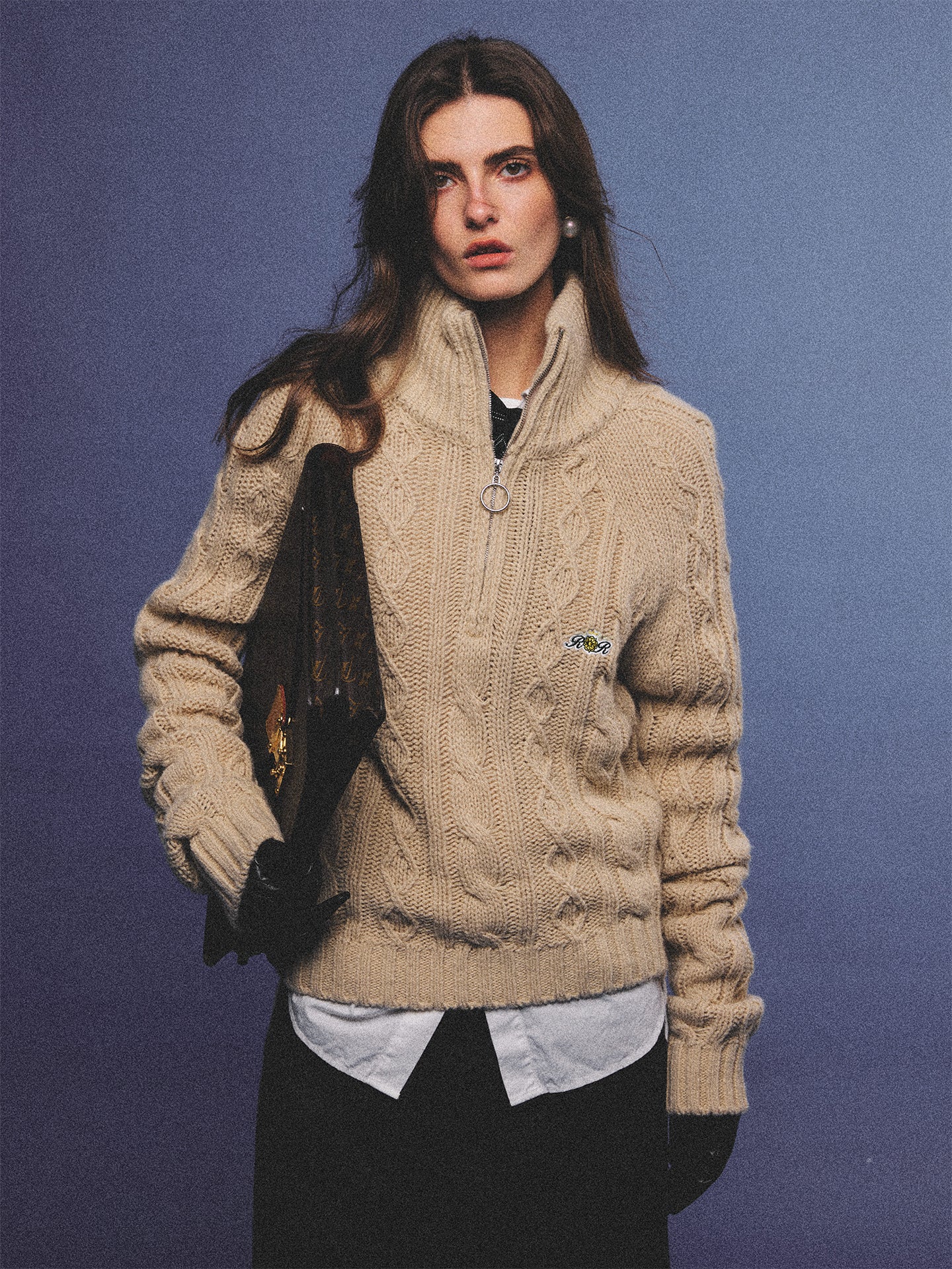Arosris oatmeal latte cable knit half-zip sweater elegantly styled on a model over a crisp white collared shirt, capturing an effortless 90s preppy and old money academia aesthetic.