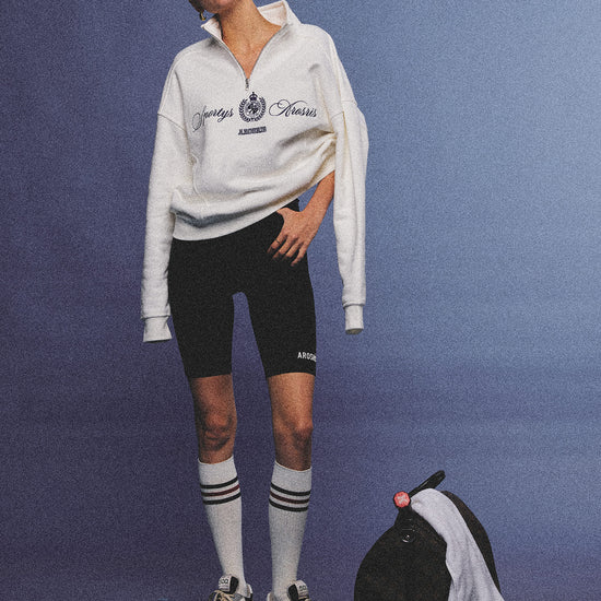 Arosris ecru vintage-inspired campus half-zip sweatshirt featuring a structured heavyweight cotton feel, styled for an unstudied 90s athletic varsity aesthetic.