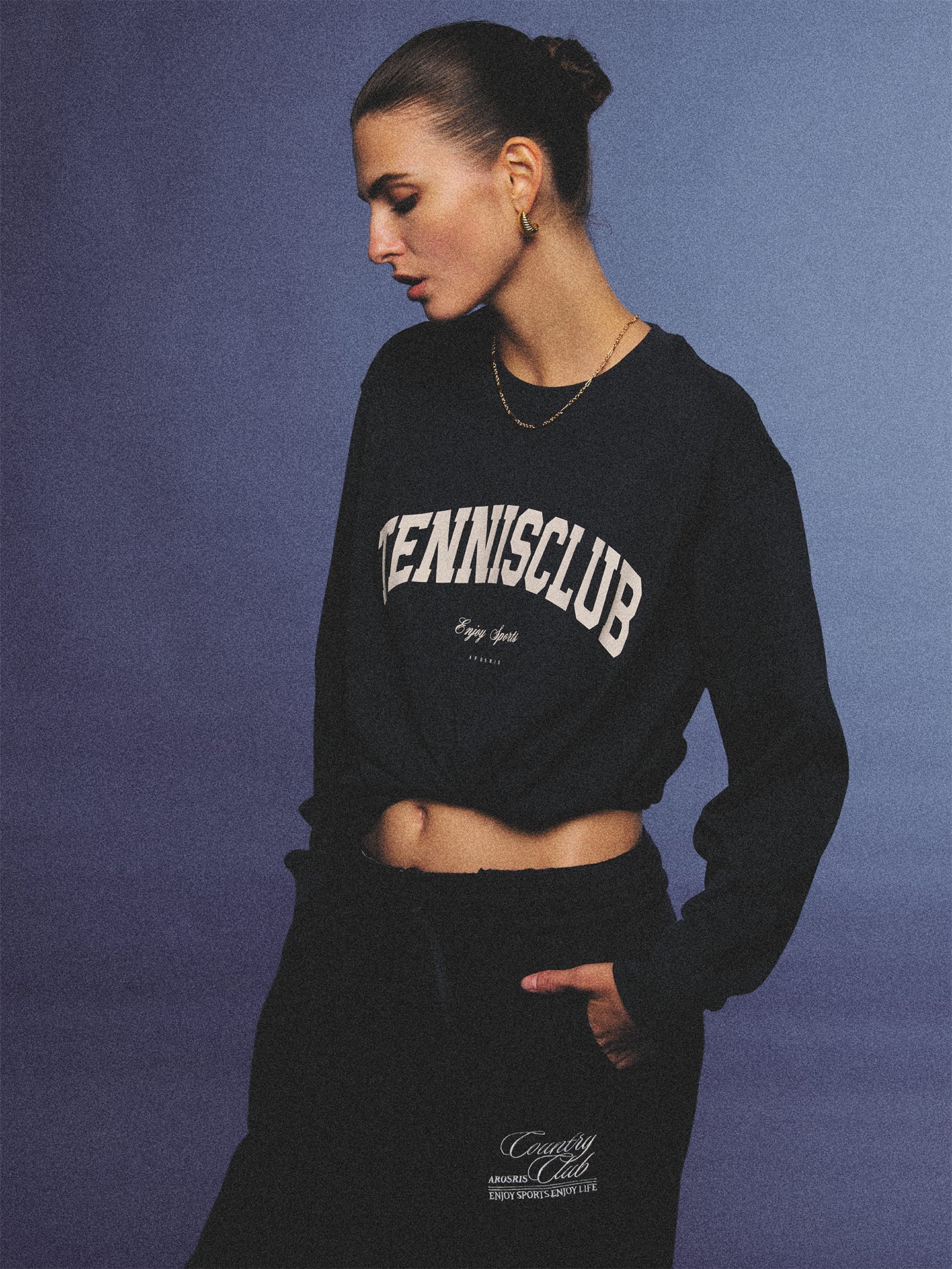 Arosris navy campus long sleeve t-shirt crafted from premium Pima cotton, featuring a vintage 'TENNISCLUB' graphic, elegantly styled with layered activewear for an effortless 90s sporty-chic aesthetic.