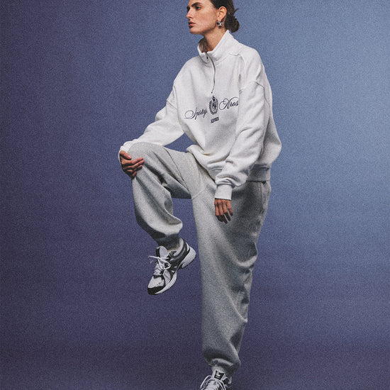 Arosris heather grey classic 100% cotton jogger sweatpants, styled with retro sneakers and layered activewear for an effortless 90s sporty-chic off-duty aesthetic.