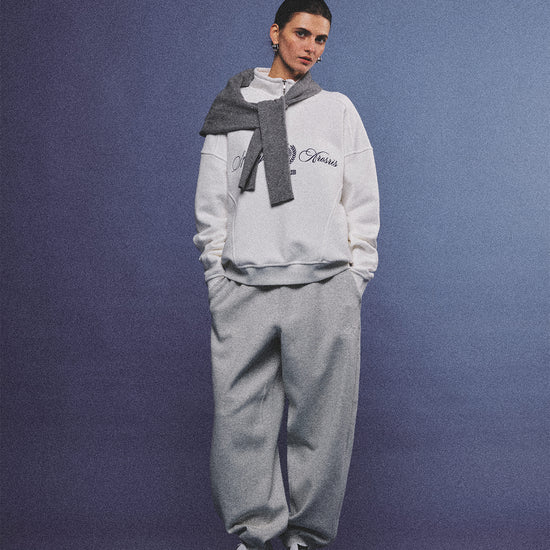 Arosris heather grey classic 100% cotton jogger sweatpants, styled with retro sneakers and layered activewear for an effortless 90s sporty-chic off-duty aesthetic.
