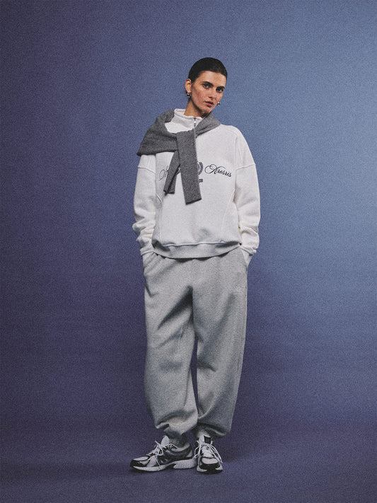 Arosris heather grey classic 100% cotton jogger sweatpants, styled with retro sneakers and layered activewear for an effortless 90s sporty-chic off-duty aesthetic.