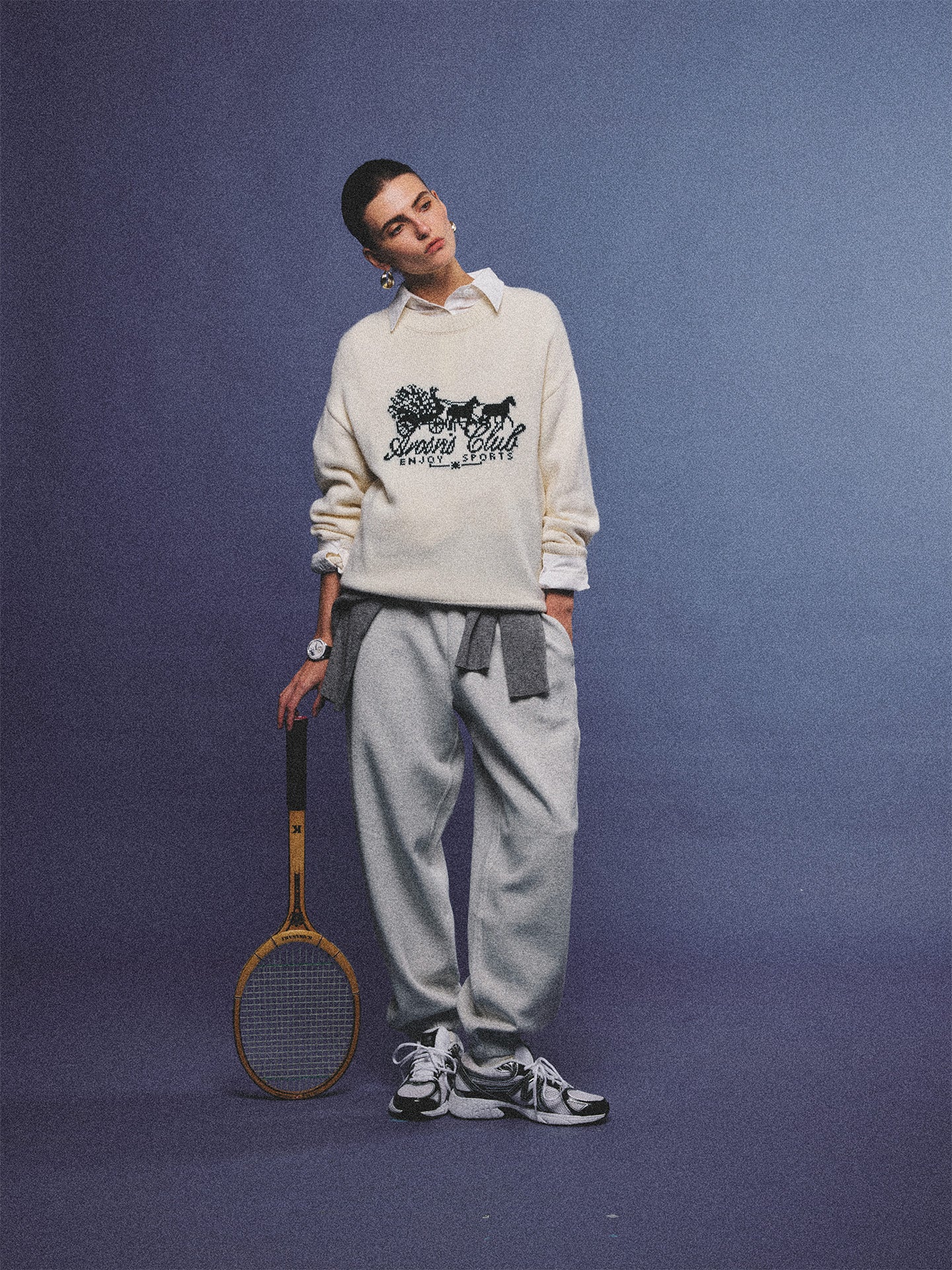 Arosris cream vintage-inspired carriage graphic wool blend sweater elegantly styled on a model with retro accessories, capturing an old money and preppy country club aesthetic.
