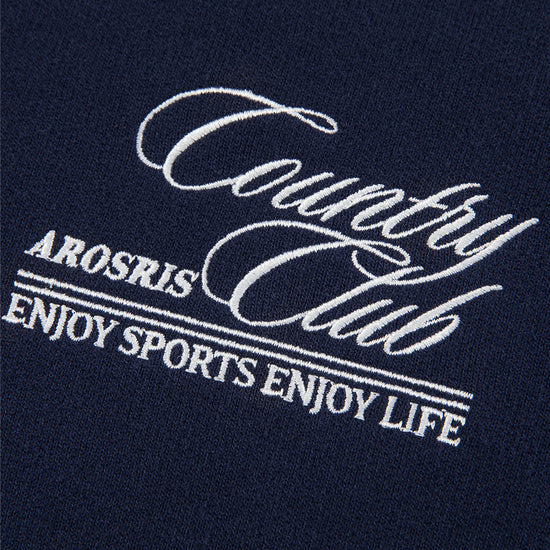 Arosris navy country club half-zip sweatshirt showcasing a structured mock neck, vintage bronze hardware, and custom script embroidery on a premium cotton blend.