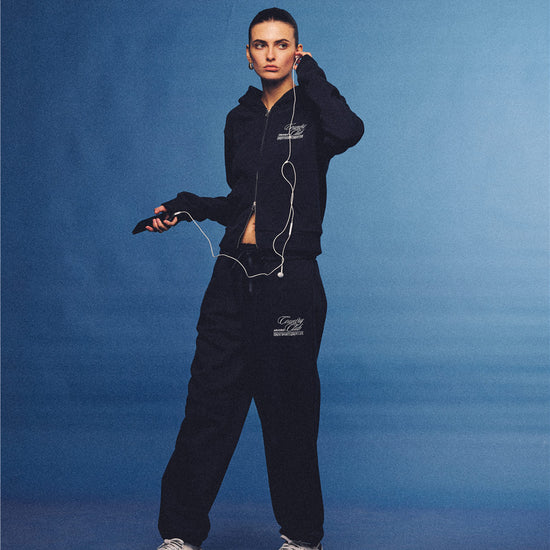 Arosris navy country club slim zip hoodie, styled with matching sweatpants and retro sneakers for an effortless 90s off-duty sporty-chic aesthetic.