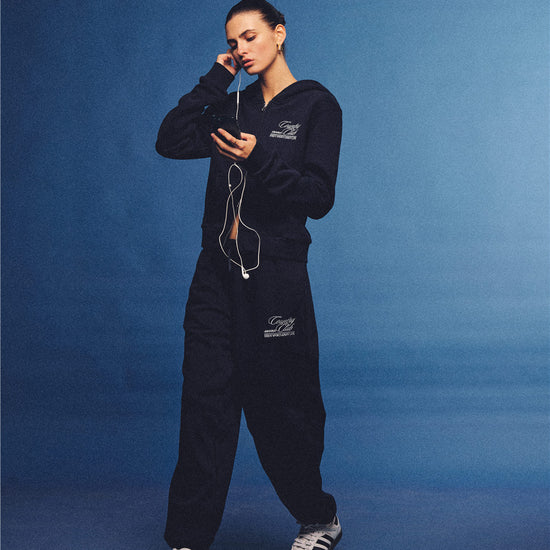 Arosris navy country club slim zip hoodie, styled with matching sweatpants and retro sneakers for an effortless 90s off-duty sporty-chic aesthetic.