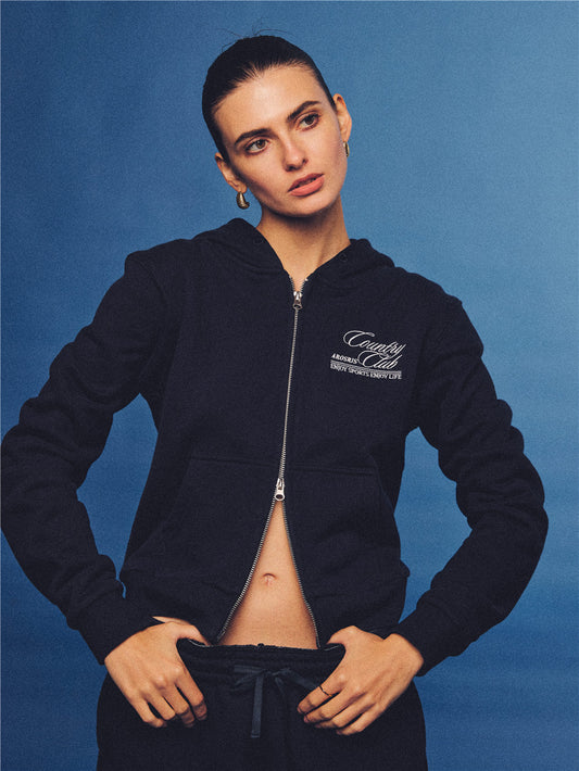 Arosris navy country club slim zip hoodie, styled with matching sweatpants and retro sneakers for an effortless 90s off-duty sporty-chic aesthetic.