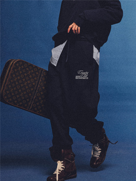 Arosris navy country club relaxed sweatpants, styled with a classic trench coat and vintage accessories for an effortless 90s sporty-rich aesthetic.