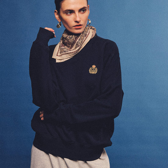 Arosris navy offshore crest crewneck sweatshirt with gold embroidery, styled with vintage accessories for an effortless 90s sporty-rich country club aesthetic.