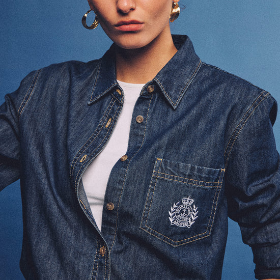 Arosris washed blue offshore crest denim shirt with nautical embroidery, styled as a cohesive 90s vintage double-denim outfit.