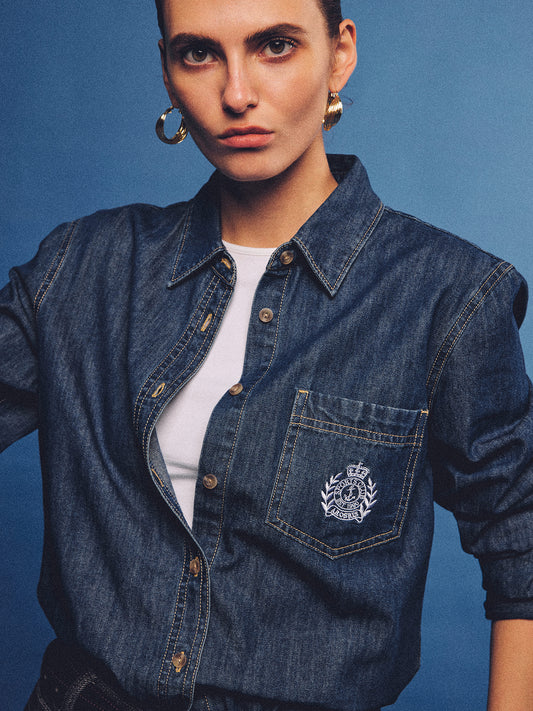Arosris washed blue offshore crest denim shirt with nautical embroidery, styled as a cohesive 90s vintage double-denim outfit.