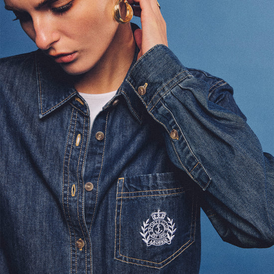 Arosris washed blue offshore crest denim shirt with nautical embroidery, styled as a cohesive 90s vintage double-denim outfit.