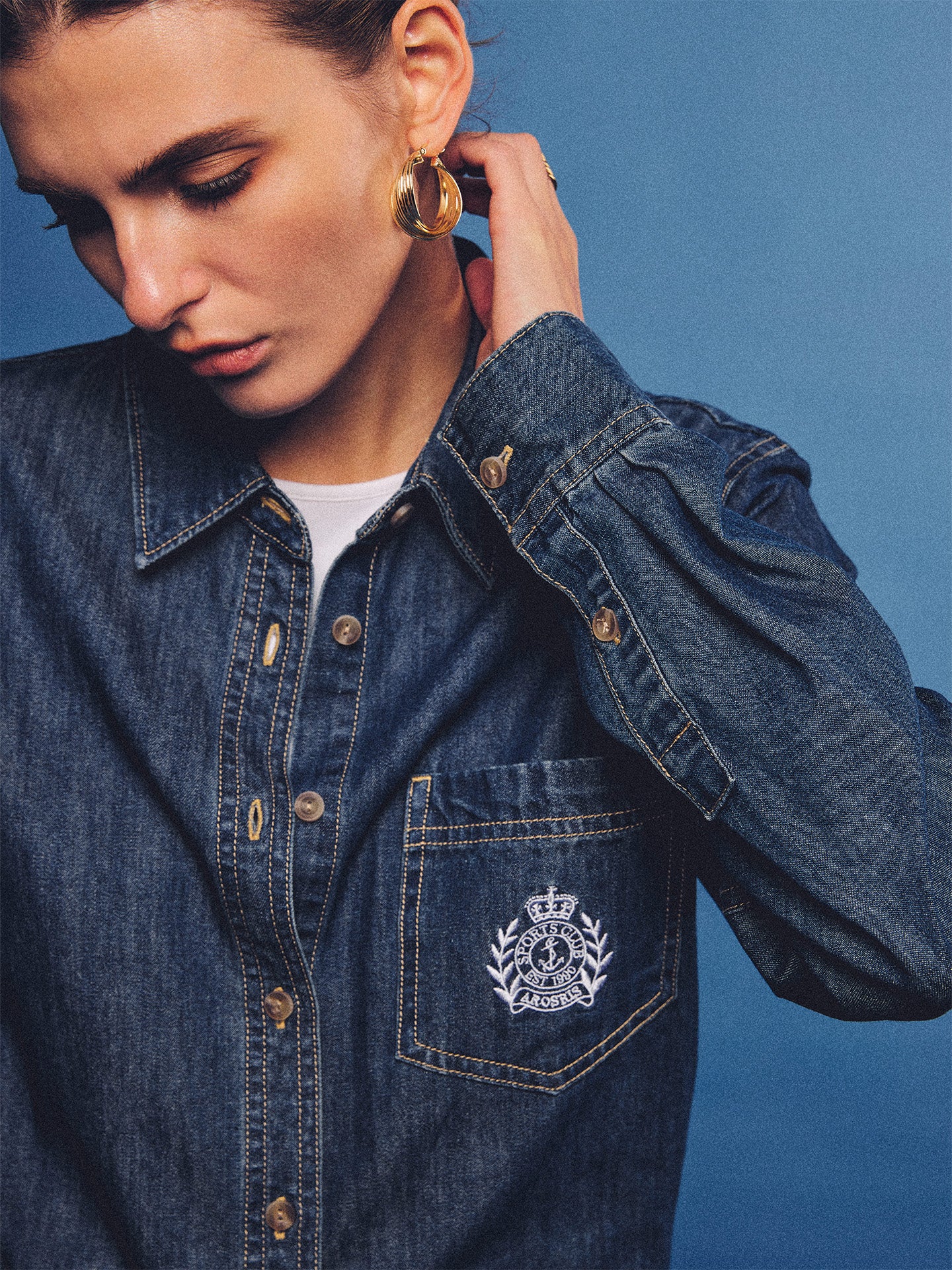 Arosris washed blue offshore crest denim shirt with nautical embroidery, styled as a cohesive 90s vintage double-denim outfit.