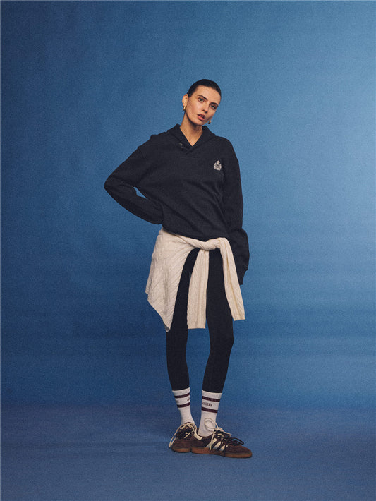 Arosris navy offshore crest shawl collar sweatshirt, styled with a tied sweater and retro sneakers for an effortless 90s vintage country club aesthetic.