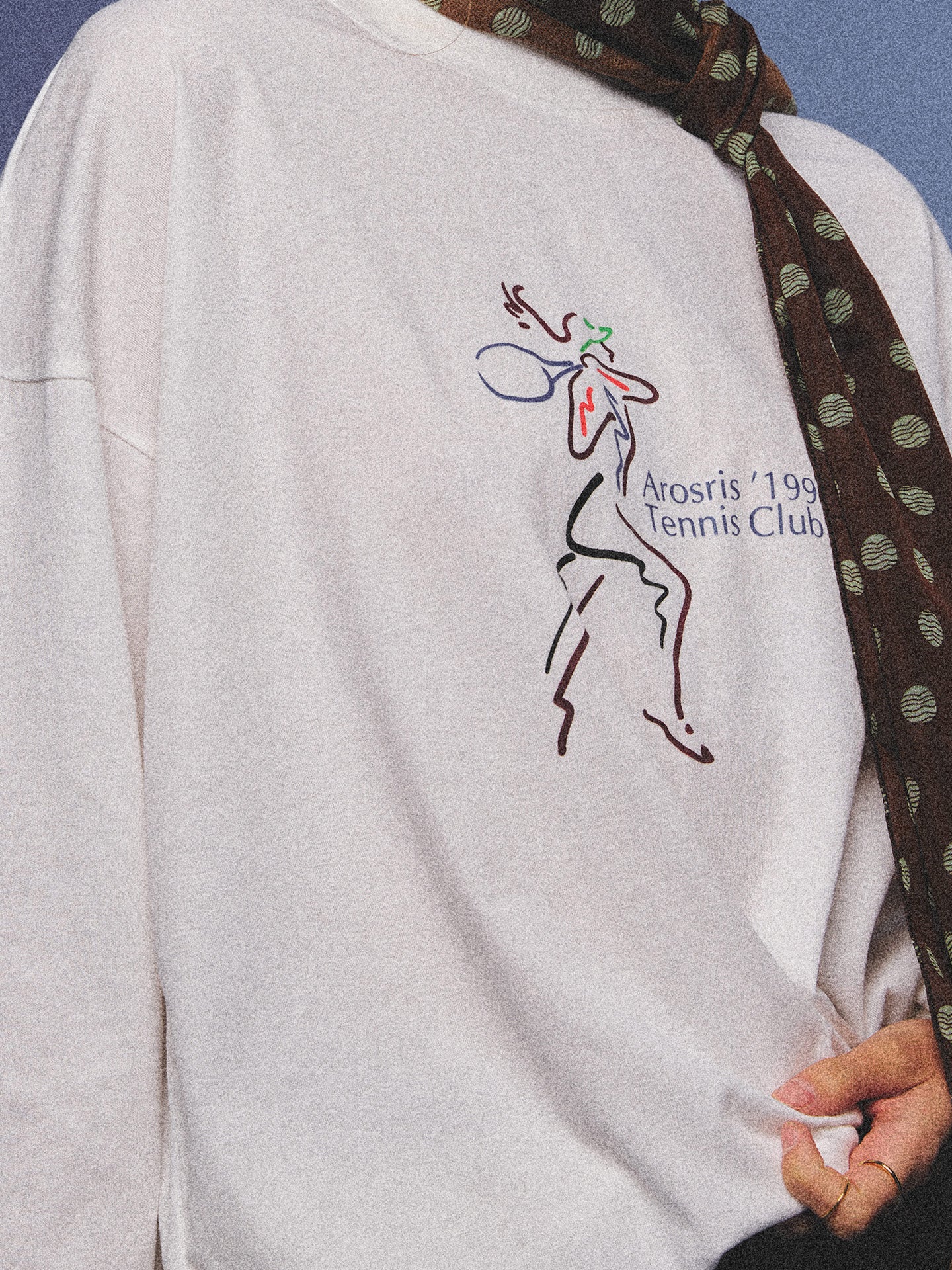 Arosris charcoal grey relaxed fit cotton t-shirt featuring a vintage 'ARR RIDING' equestrian horse graphic, styled on a model with wide-leg denim and a suede tote bag for an effortless 90s country club off-duty aesthetic.