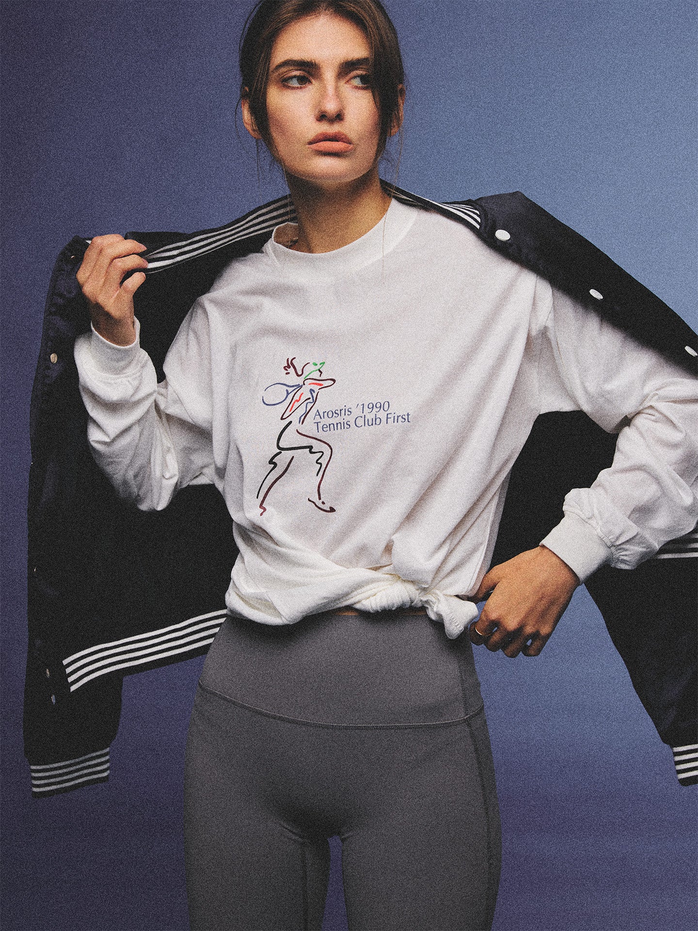 Arosris charcoal grey relaxed fit cotton t-shirt featuring a vintage 'ARR RIDING' equestrian horse graphic, styled on a model with wide-leg denim and a suede tote bag for an effortless 90s country club off-duty aesthetic.