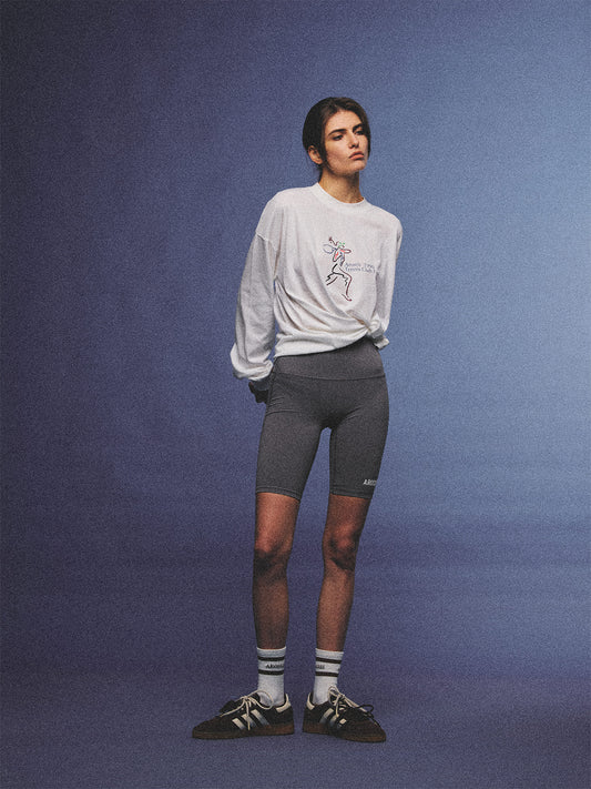 Arosris charcoal grey relaxed fit cotton t-shirt featuring a vintage 'ARR RIDING' equestrian horse graphic, styled on a model with wide-leg denim and a suede tote bag for an effortless 90s country club off-duty aesthetic.