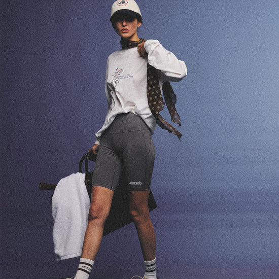 Arosris charcoal grey relaxed fit cotton t-shirt featuring a vintage 'ARR RIDING' equestrian horse graphic, styled on a model with wide-leg denim and a suede tote bag for an effortless 90s country club off-duty aesthetic.