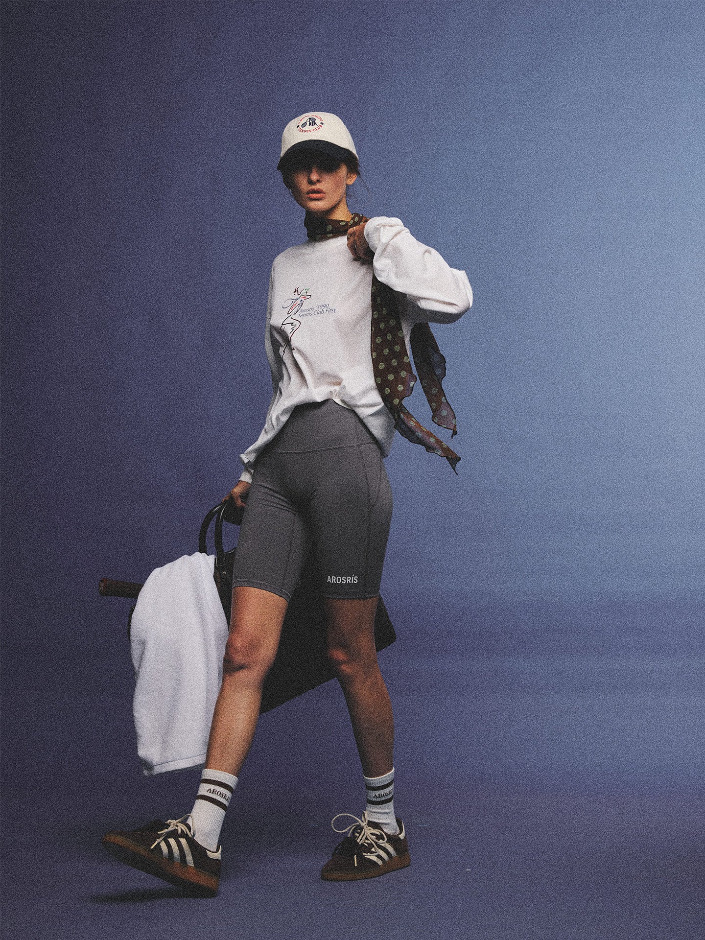 Arosris charcoal grey relaxed fit cotton t-shirt featuring a vintage 'ARR RIDING' equestrian horse graphic, styled on a model with wide-leg denim and a suede tote bag for an effortless 90s country club off-duty aesthetic.