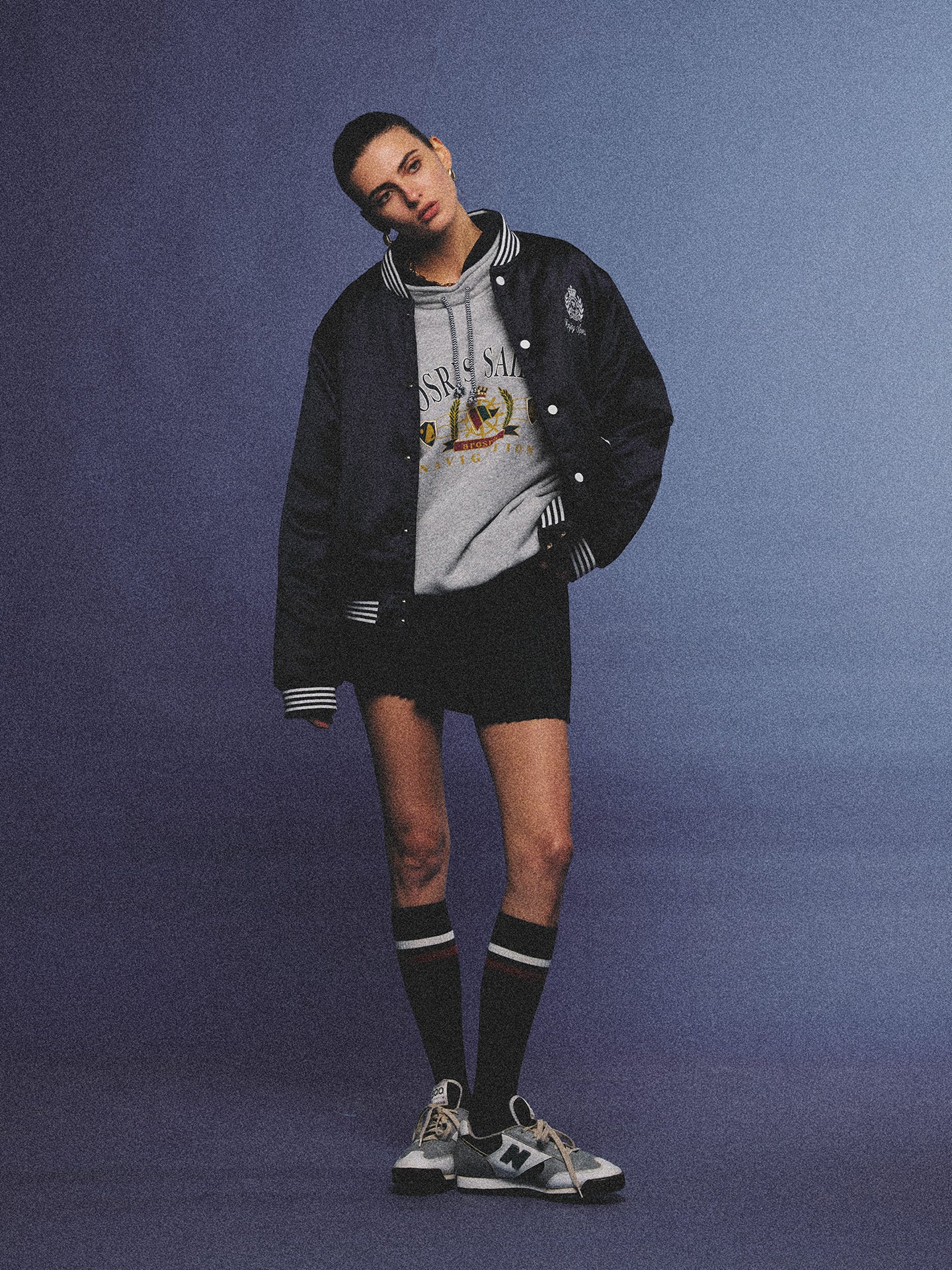 Arosris midnight navy high-gloss satin padded bomber jacket featuring a bold vintage club back embroidery, styled for an effortless 90s sporty-chic varsity aesthetic.