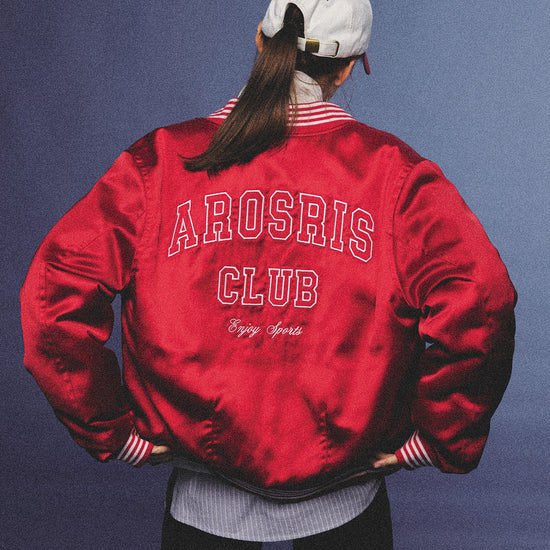 Arosris cherry red high-gloss satin padded bomber jacket featuring a bold vintage club back embroidery, styled with retro accessories for a striking 90s sporty-chic aesthetic.