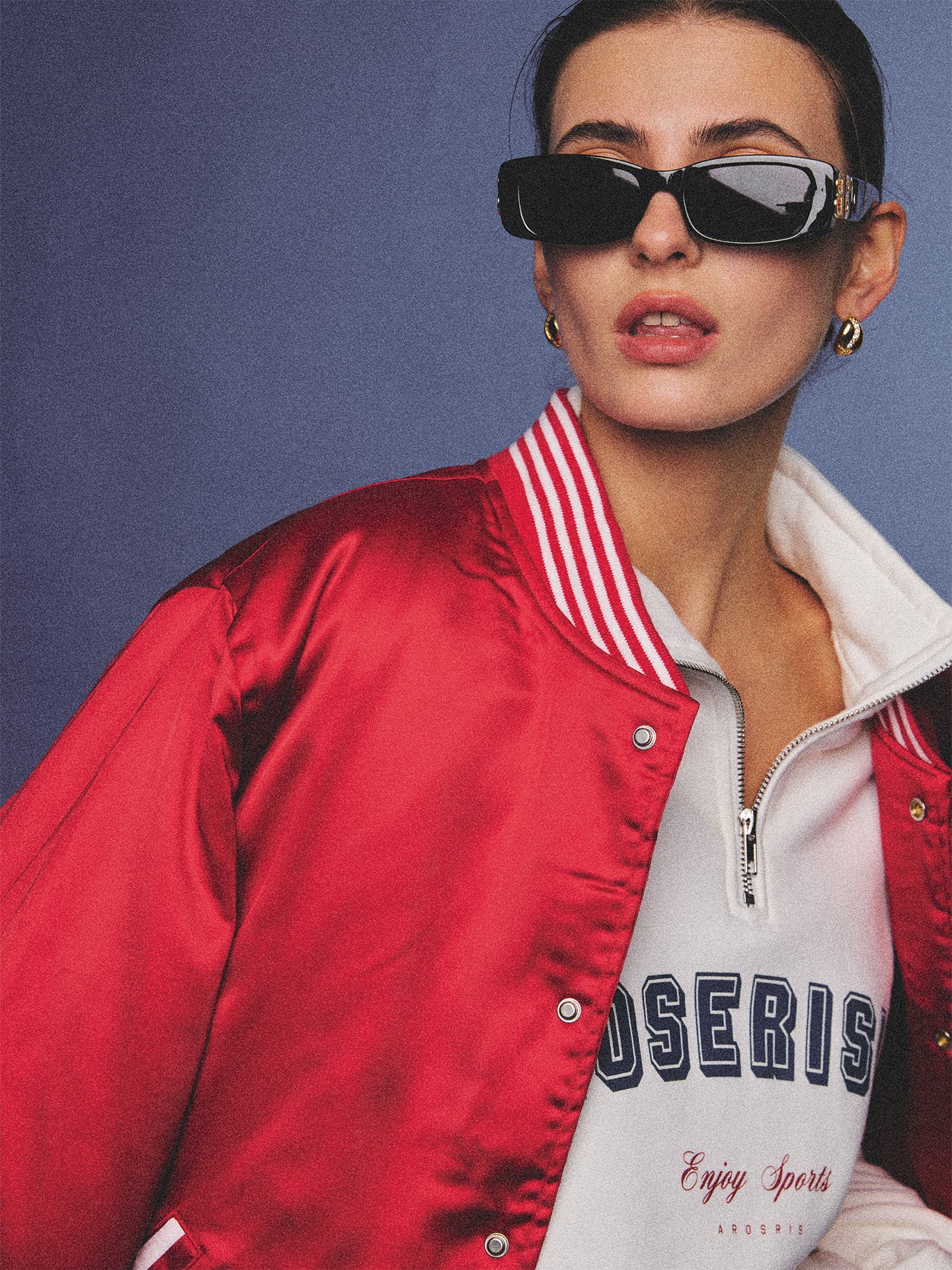 Arosris cherry red high-gloss satin padded bomber jacket featuring a bold vintage club back embroidery, styled with retro accessories for a striking 90s sporty-chic aesthetic.