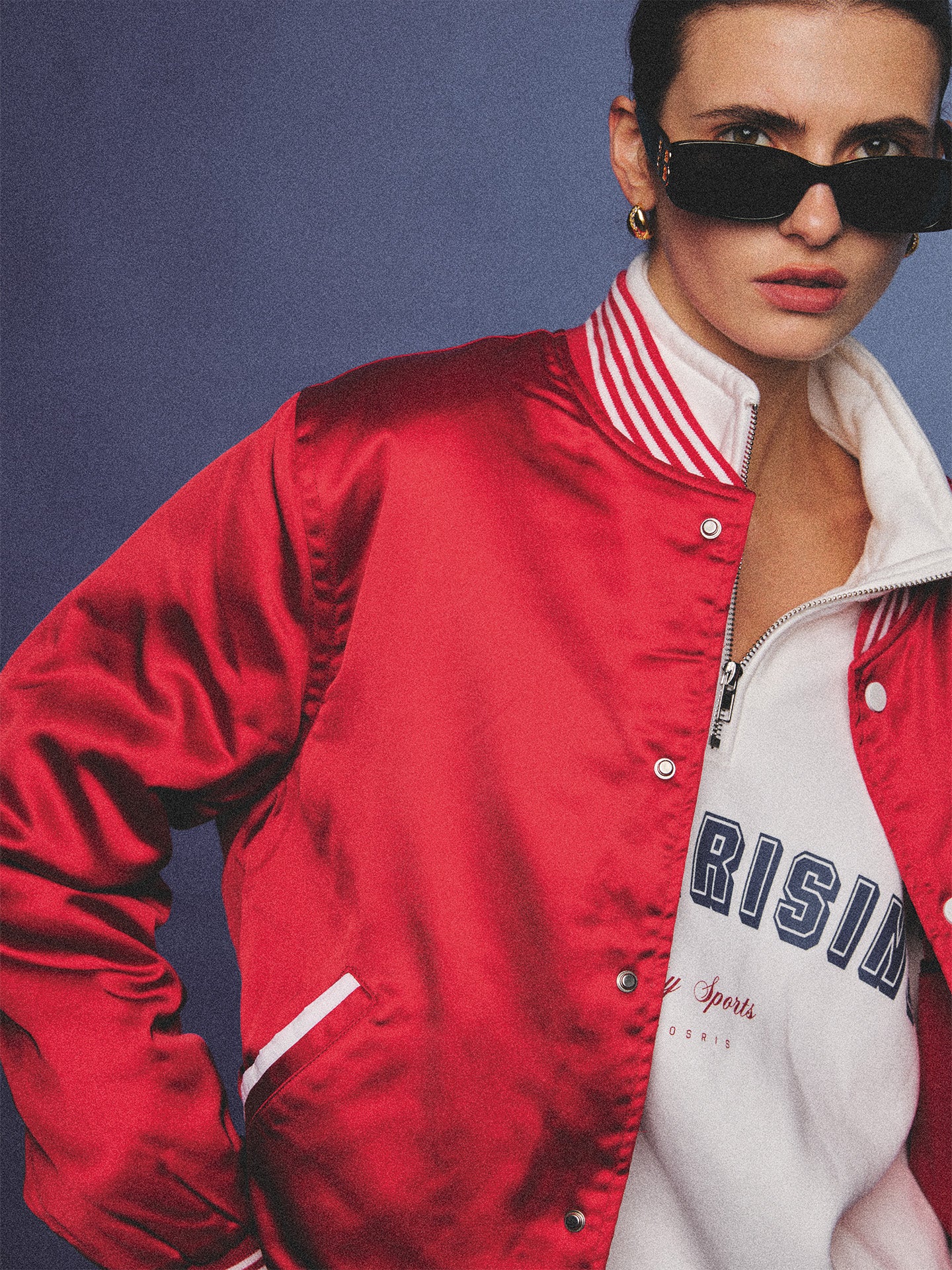 Arosris cherry red high-gloss satin padded bomber jacket featuring a bold vintage club back embroidery, styled with retro accessories for a striking 90s sporty-chic aesthetic.