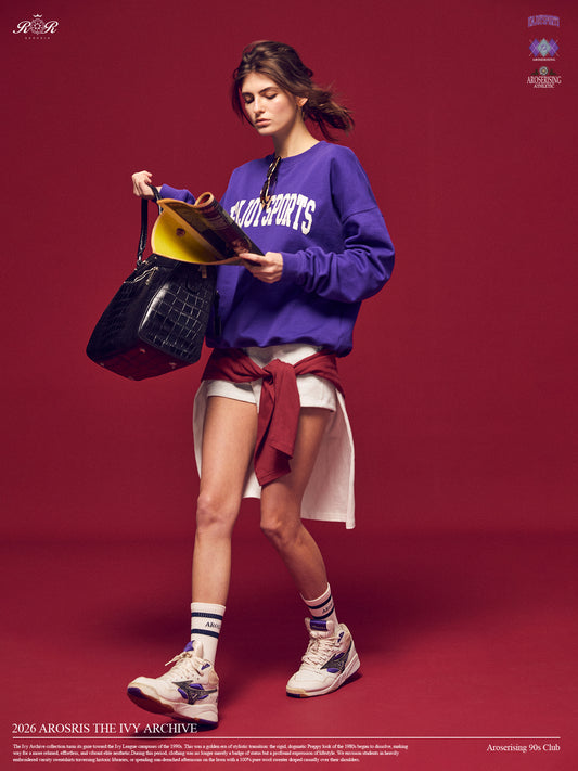 Arosris Ivy Archive Enjoy Sports crewneck sweatshirt in purple, styled with white shorts, sneakers, and a basketball for an effortless 90s off-duty street style look.