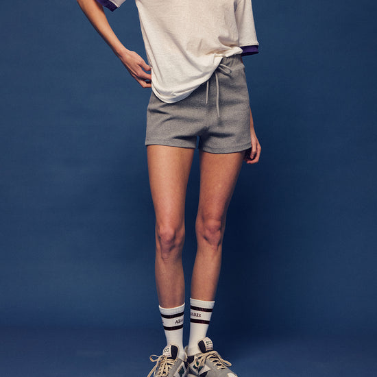 Master the retro 90s athletic aesthetic with the Ivy Archive Mid-Thigh Track Shorts. Featuring a flattering high-rise waist, modest mid-thigh coverage, and premium stretch cotton.
