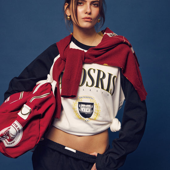 Arosris Ivy Archive collegiate raglan long sleeve in navy, styled with sweatpants and a retro Walkman for an effortless 90s vintage varsity look.