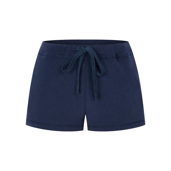 Arosris Ivy Archive high-rise varsity shorts featuring a 3-inch inseam and thick drawstring, elegantly styled on a model for an effortless 90s collegiate and sporty rich aesthetic.