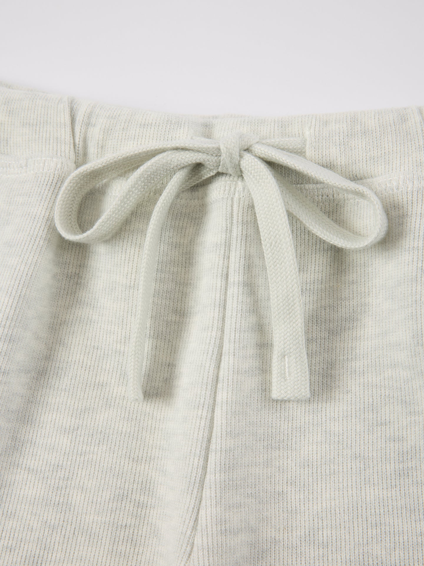 Arosris Ivy Archive high-rise varsity shorts featuring a 3-inch inseam and thick drawstring, elegantly styled on a model for an effortless 90s collegiate and sporty rich aesthetic.