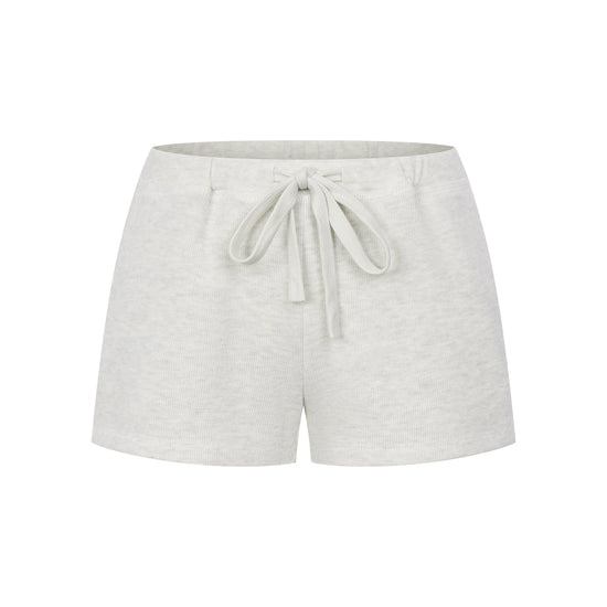 Arosris Ivy Archive high-rise varsity shorts featuring a 3-inch inseam and thick drawstring, elegantly styled on a model for an effortless 90s collegiate and sporty rich aesthetic.