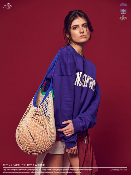 Arosris Ivy Archive Enjoy Sports crewneck sweatshirt in purple, styled with white shorts, sneakers, and a basketball for an effortless 90s off-duty street style look.