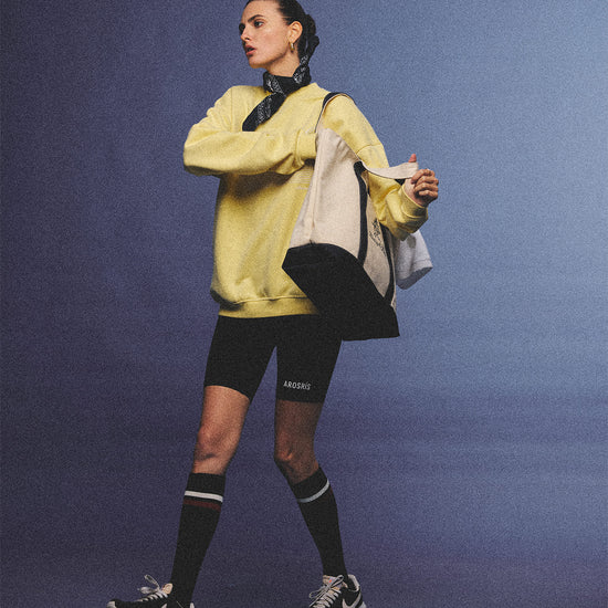 Arosris vintage white lightweight graphic training top crafted from breathable semi-sheer fabric, featuring a retro tennis sport graphic, elegantly styled for an effortless 90s sporty rich and off-duty athletic aesthetic.