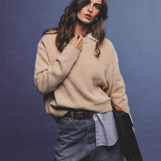 Arosris greige modern chic cashmere chunky knit sweater elegantly styled on a model over a crisp collared shirt, channeling an old money and quiet luxury aesthetic.