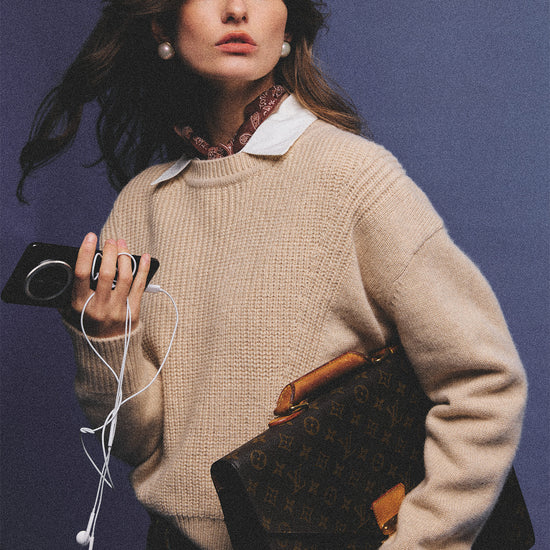 Arosris greige modern chic cashmere chunky knit sweater elegantly styled on a model over a crisp collared shirt, channeling an old money and quiet luxury aesthetic.