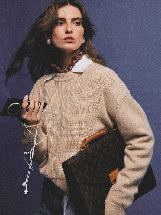 Arosris greige modern chic cashmere chunky knit sweater elegantly styled on a model over a crisp collared shirt, channeling an old money and quiet luxury aesthetic.