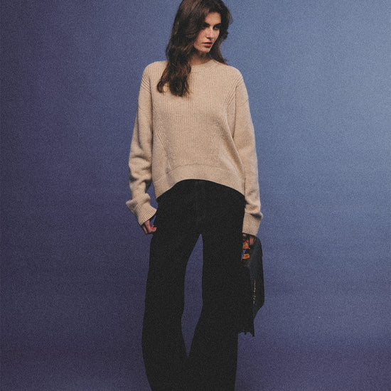 Arosris greige modern chic cashmere chunky knit sweater elegantly styled on a model over a crisp collared shirt, channeling an old money and quiet luxury aesthetic.