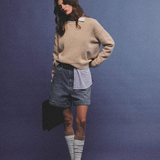 Arosris greige modern chic cashmere chunky knit sweater elegantly styled on a model over a crisp collared shirt, channeling an old money and quiet luxury aesthetic.