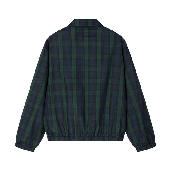 Arosris offshore Harrington jacket in classic navy and green Blackwatch tartan, styled with wide-leg jeans for a 90s vintage nautical look.