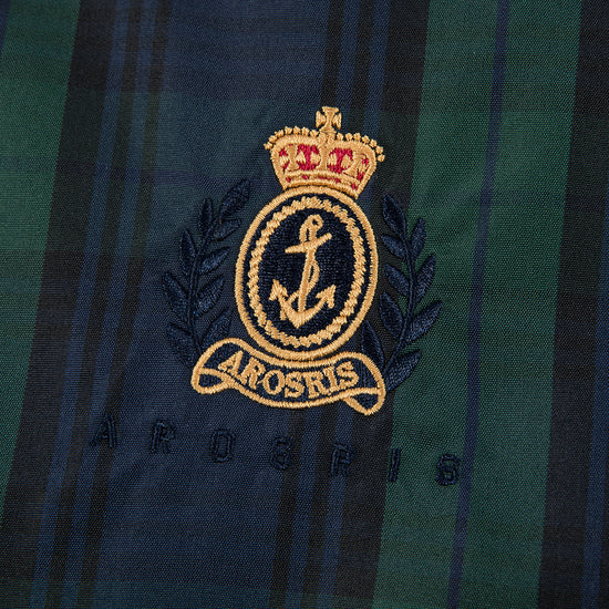 Arosris offshore Harrington jacket in classic navy and green Blackwatch tartan, styled with wide-leg jeans for a 90s vintage nautical look.