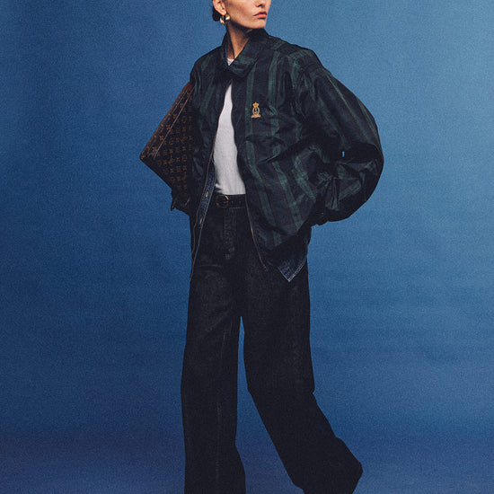 Arosris offshore high-rise wide-leg jeans in vintage indigo, styled with a classic jacket and accessories for an effortless 90s retro look.