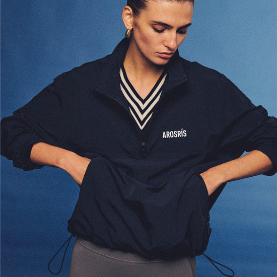 Arosris navy retro sport half-zip windproof jacket, styled with athletic leggings and layered accessories for an effortless 90s sporty-chic country club aesthetic.
