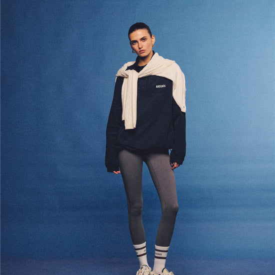 Arosris navy retro sport half-zip windproof jacket, styled with athletic leggings and layered accessories for an effortless 90s sporty-chic country club aesthetic.