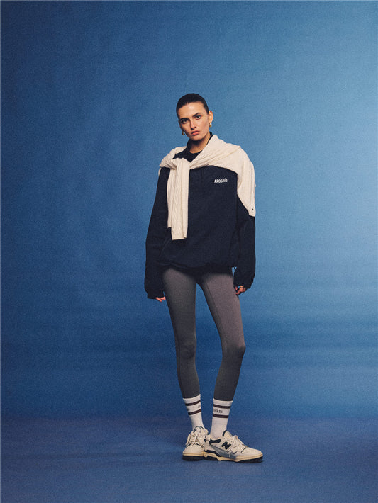Arosris navy retro sport half-zip windproof jacket, styled with athletic leggings and layered accessories for an effortless 90s sporty-chic country club aesthetic.