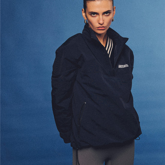 Arosris navy retro sport half-zip windproof jacket, styled with athletic leggings and layered accessories for an effortless 90s sporty-chic country club aesthetic.