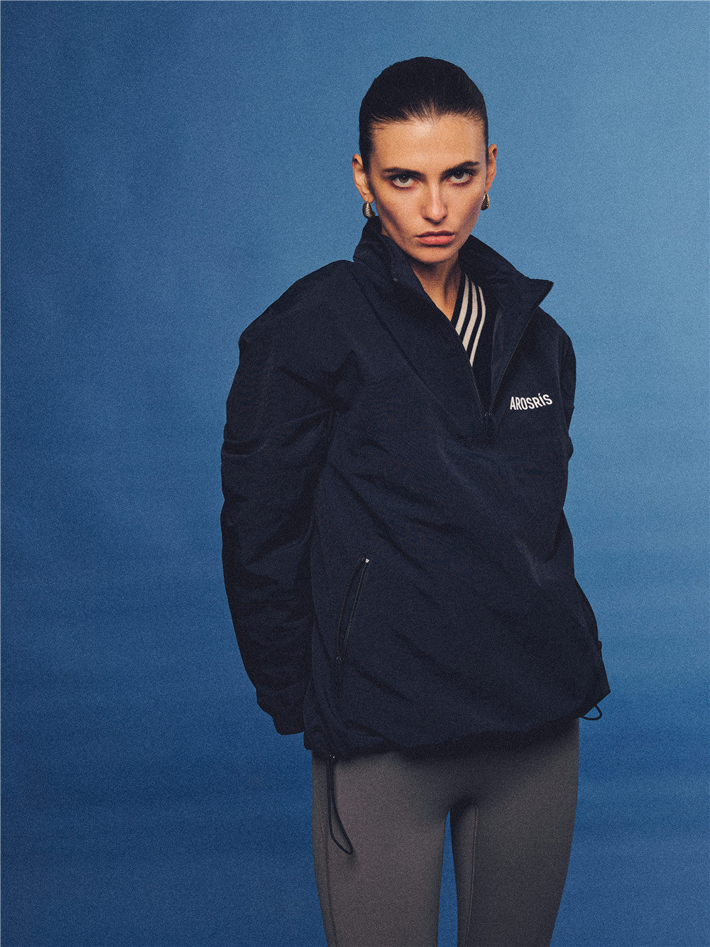 Arosris navy retro sport half-zip windproof jacket, styled with athletic leggings and layered accessories for an effortless 90s sporty-chic country club aesthetic.