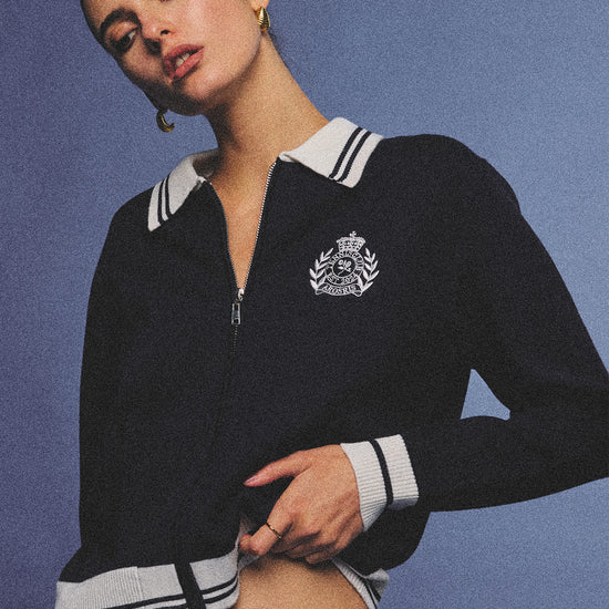 Arosris royal sapphire blue retro zip-up polo knit featuring a contrast tipped collar and vintage tennis club crest, elegantly styled for an effortless 90s old money tenniscore aesthetic.