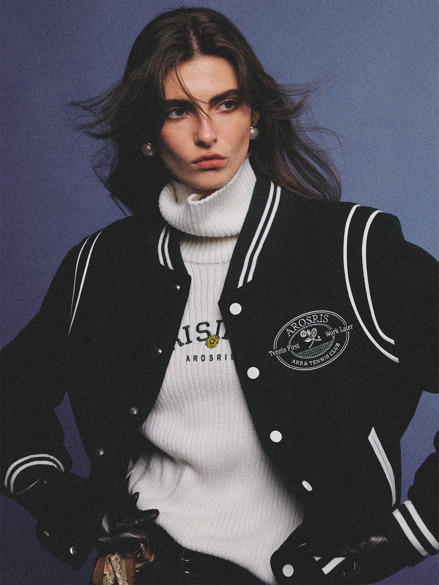 Arosris classic modern white ribbed wool blend turtleneck featuring a vintage 'RISING' floral embroidery, elegantly styled on a model as an effortless 90s preppy foundational layering piece.